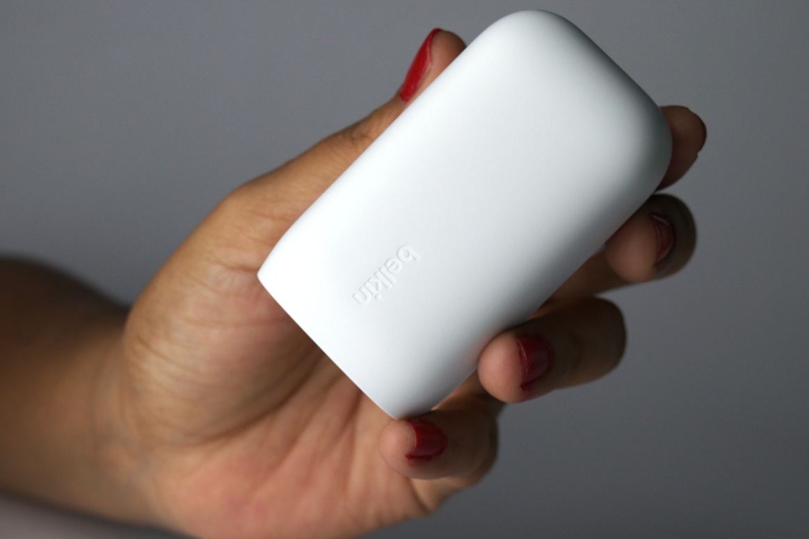 White Belkin power charger held in hand