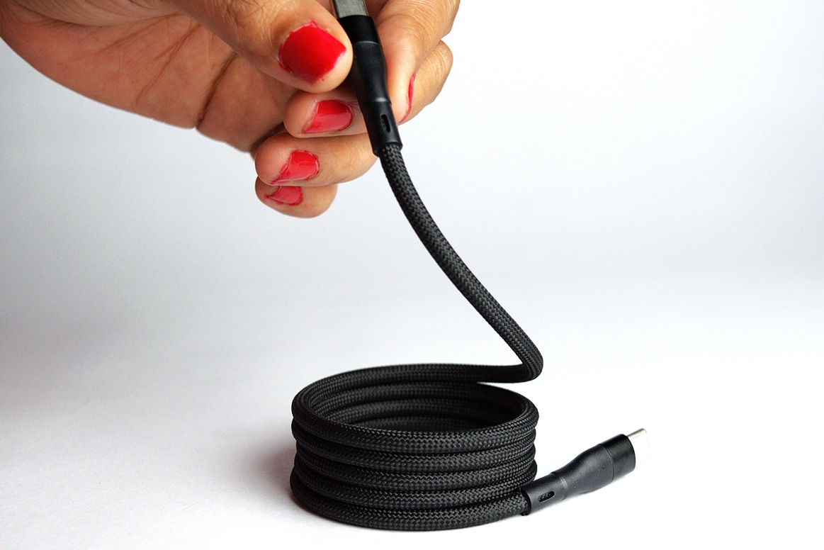 Holding one end of the magnetic USB-C to USB-C braided power cable