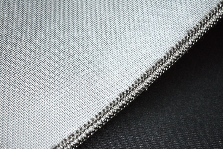 Thick rubber base and stitched edges on a fabric gaming desk mat