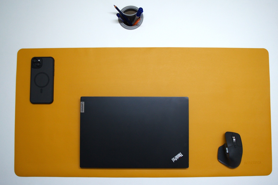 Thinkpad and Logitech wireless mouse on a yellow colored professional desk mat