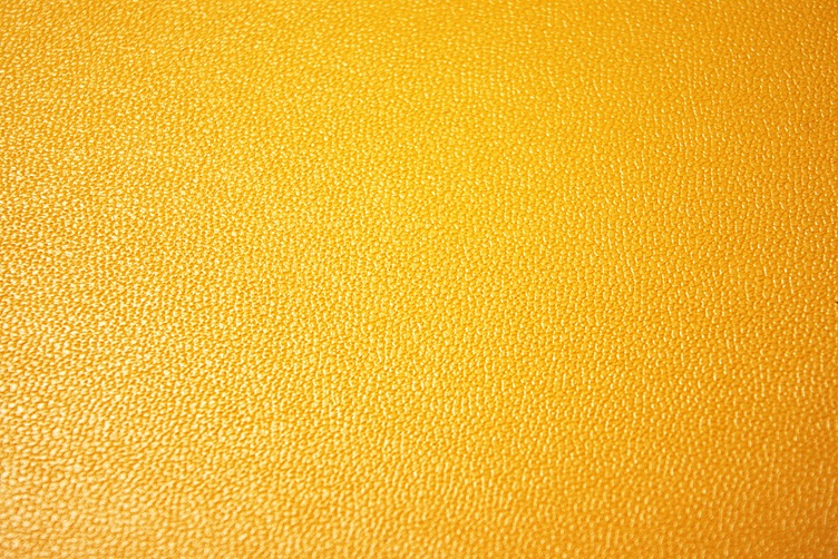 Surface pattern on a yellow colored professional desk mat