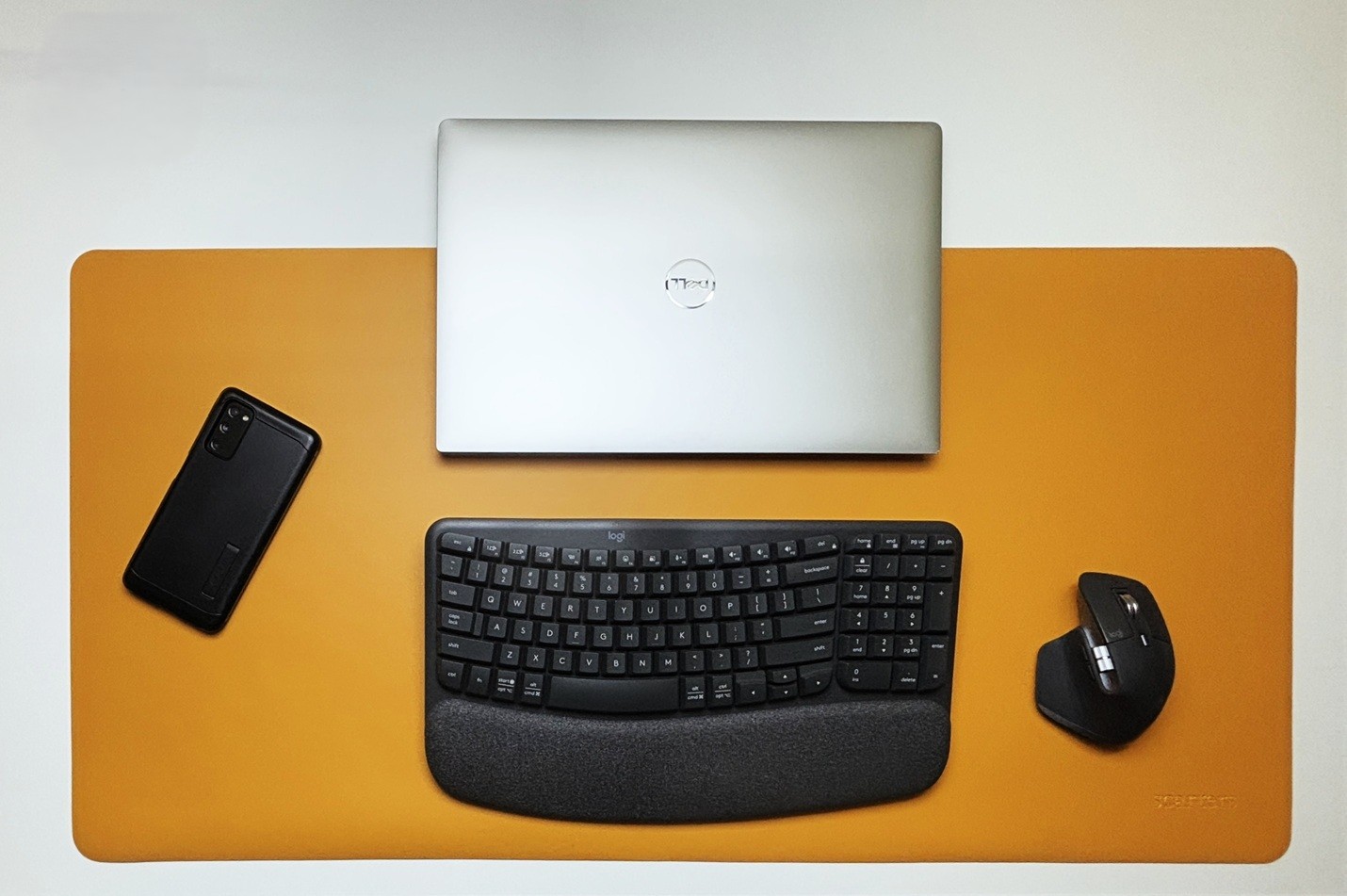 Dell XPS, Logitech wireless mouse and keyboard on a yellow colored professional desk mat