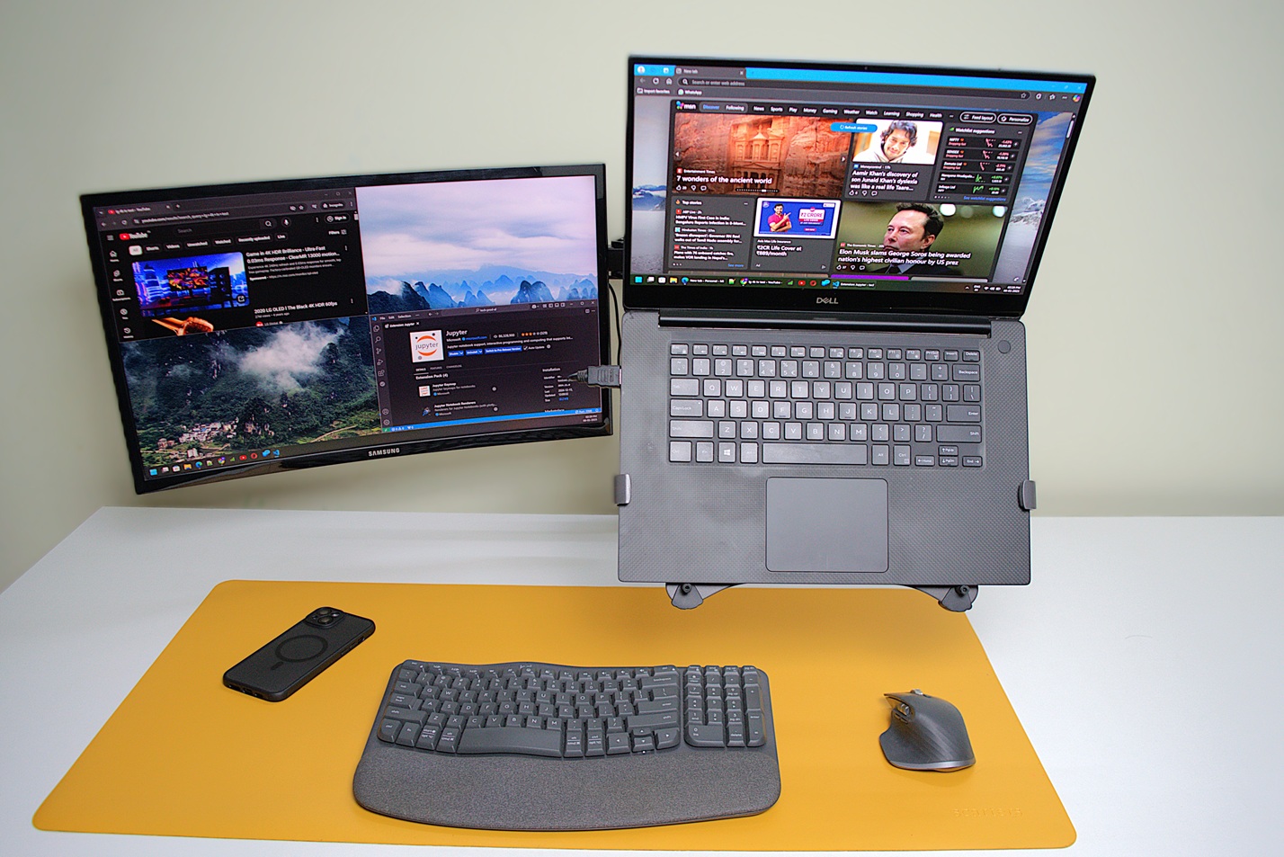 Laptop and a monitor on a dual arm setup, laptop pulled forward