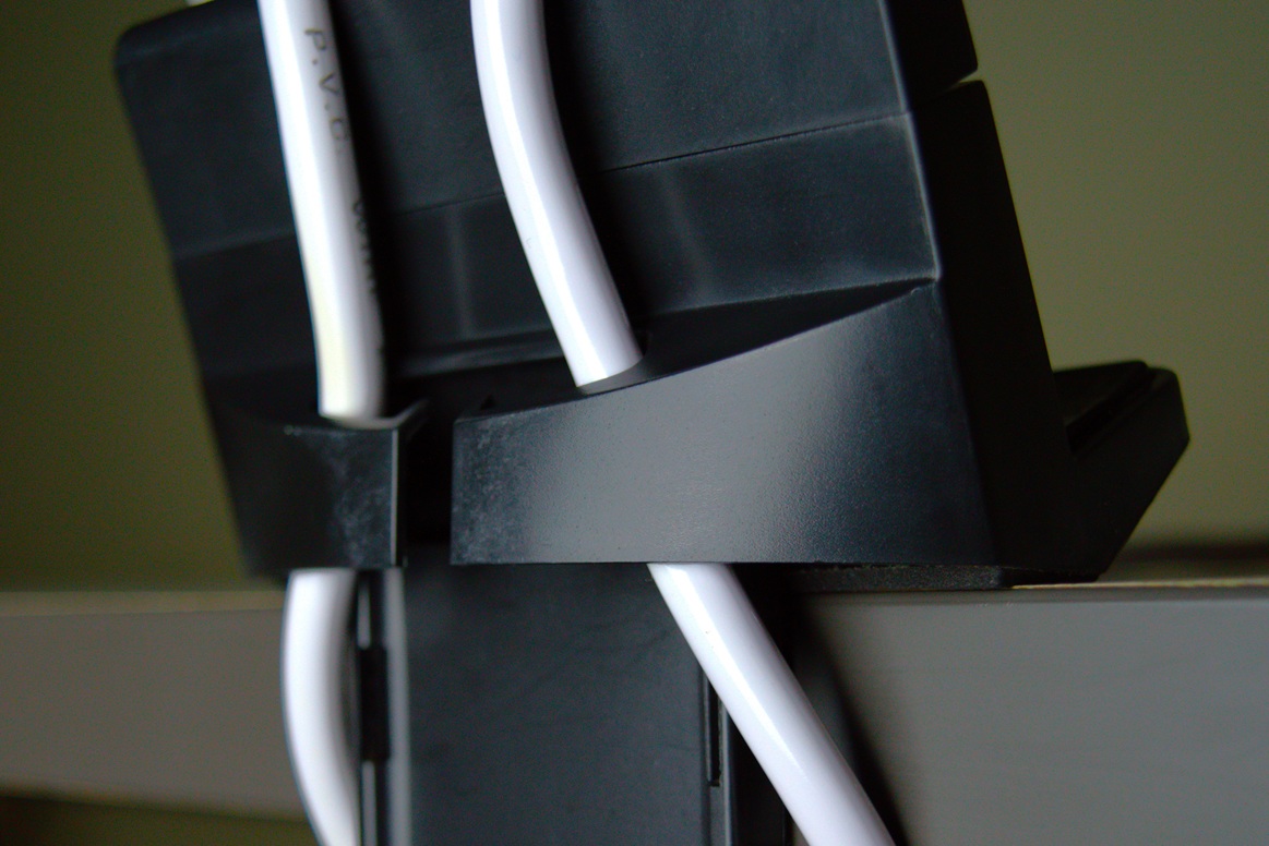 Cable clamp of the power strip holder holding power cables