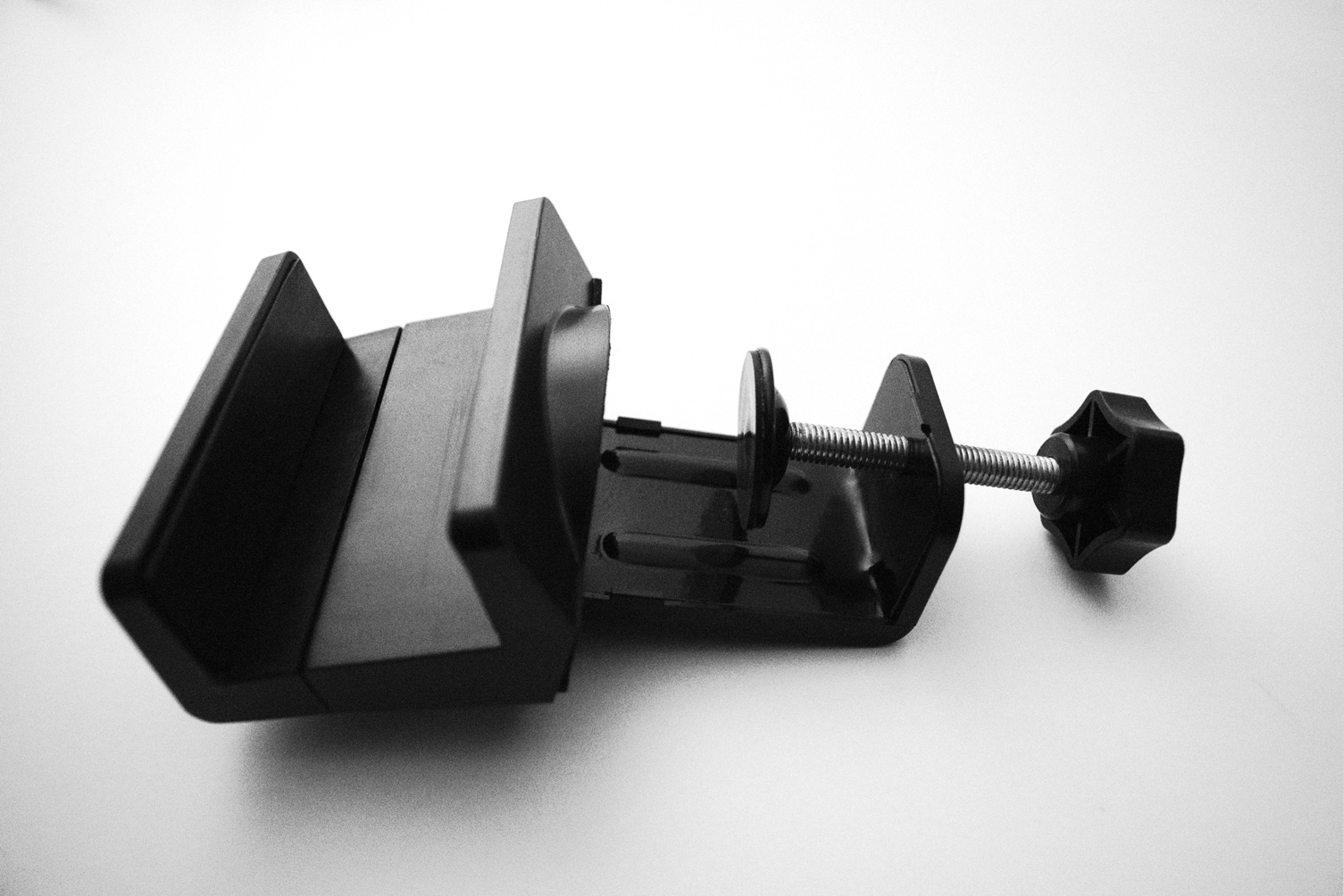 Black power strip holder on a white desk