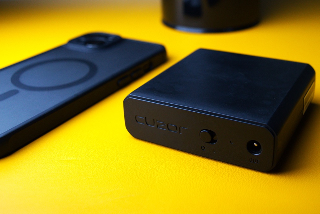 Mini UPS next to an iPhone for comparison on how compact it is