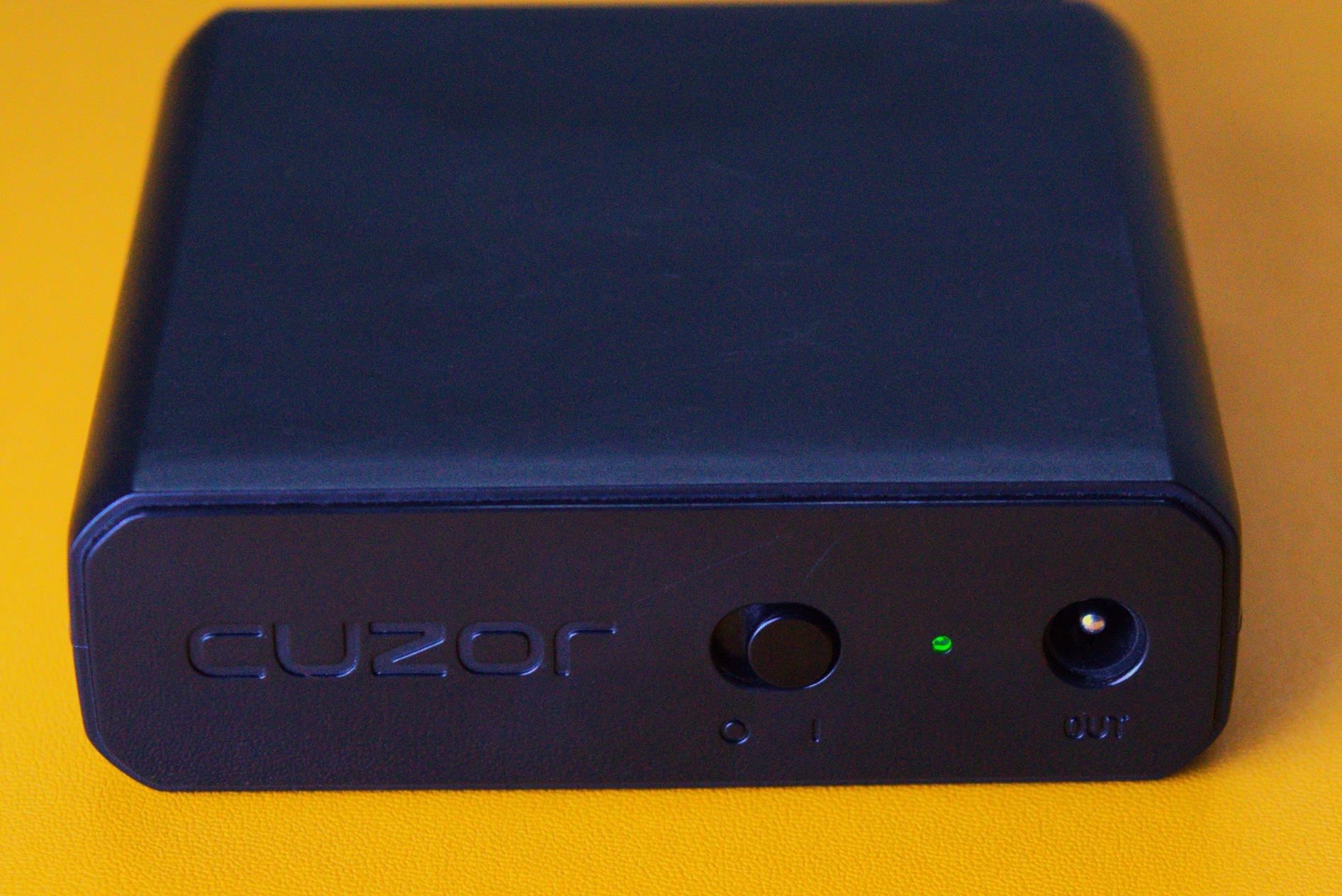 Mini UPS for router shows green power available indicator