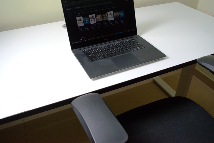 Laptop on a white electric standing desk