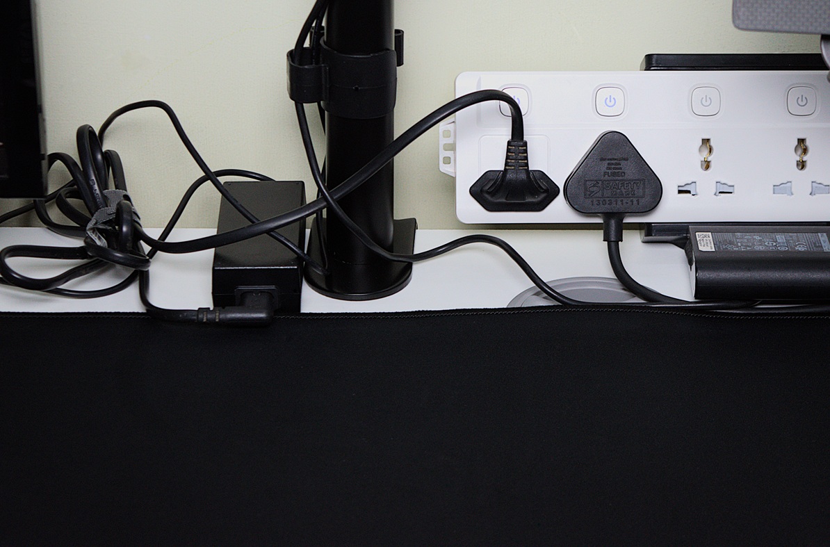 Cluttered desk space without under desk tray