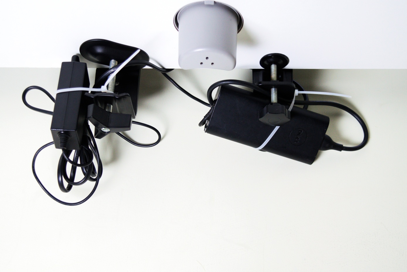 Power adaptors left hanging beneath the desk