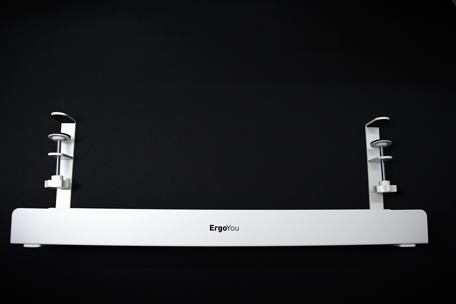 Assembled white under desk tray on a black desk mat