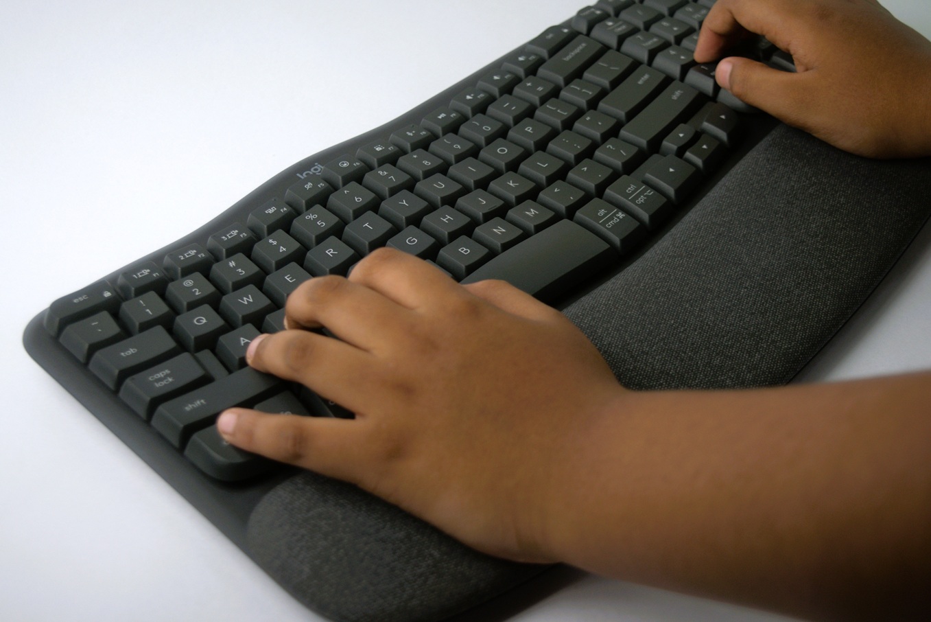Logitech wave keys keyboard used by a toddler